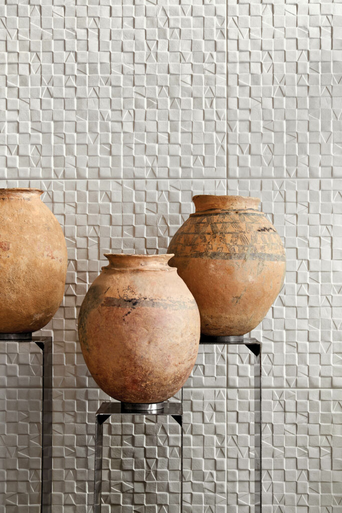 three terra cotta pots near a tiled ceramic wall