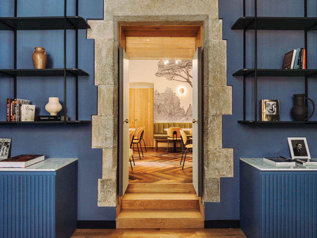blue kitchen with open doorway facing another room