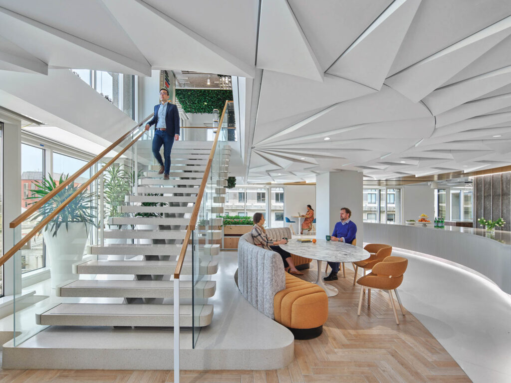 office lobby with stairs and starburst symbol on ceiling