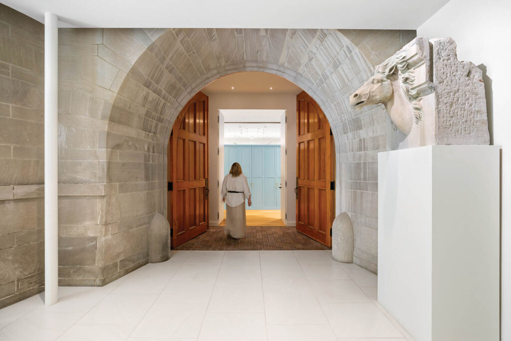 an arched hallway in a historic carriage house turned office