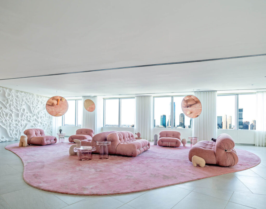 an office interior with pink furnishings and a pink carpet