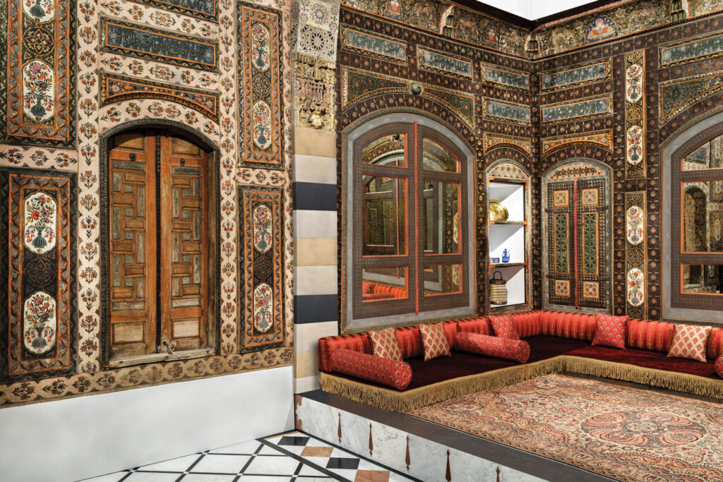 Damascus Room featuring ornate wall coverings and red low sofas