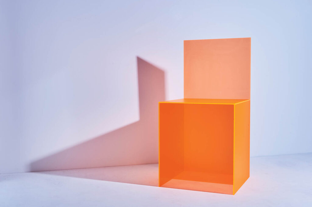 an orange acrylic chair