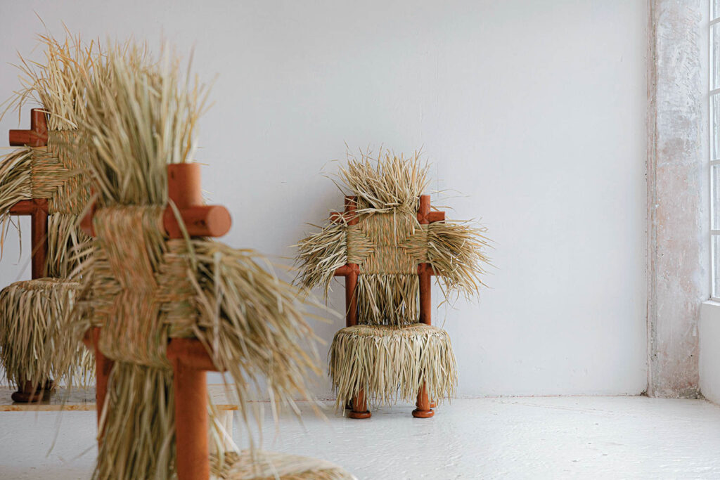 a whimsical chair with a woven straw backing and seat