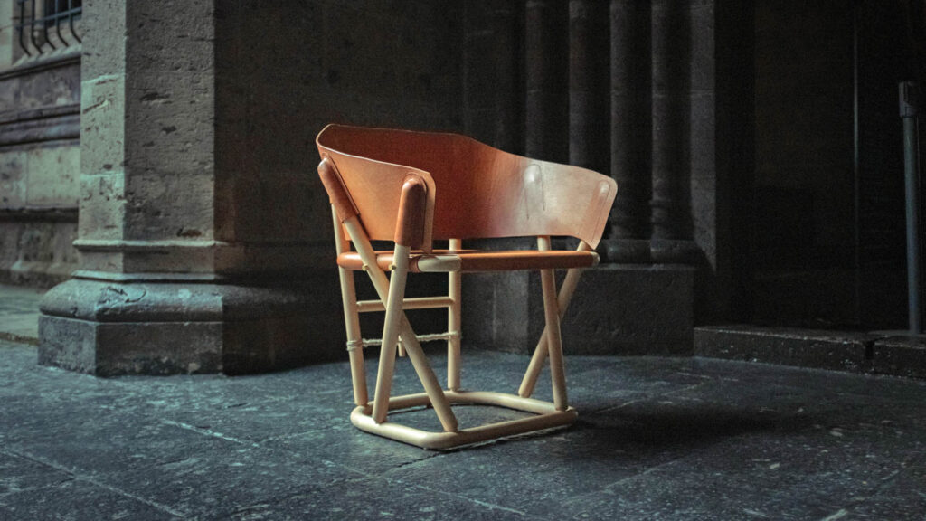 a wooden curved armchair with raised legs