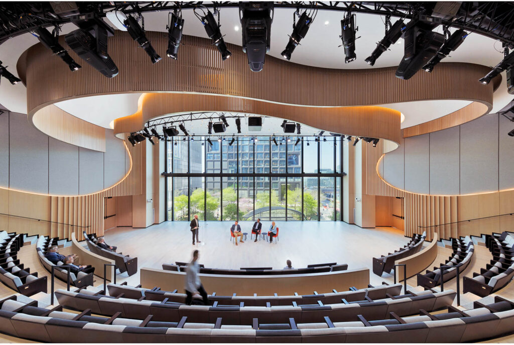 auditorium with stage and seats underneath amorphous ceiling