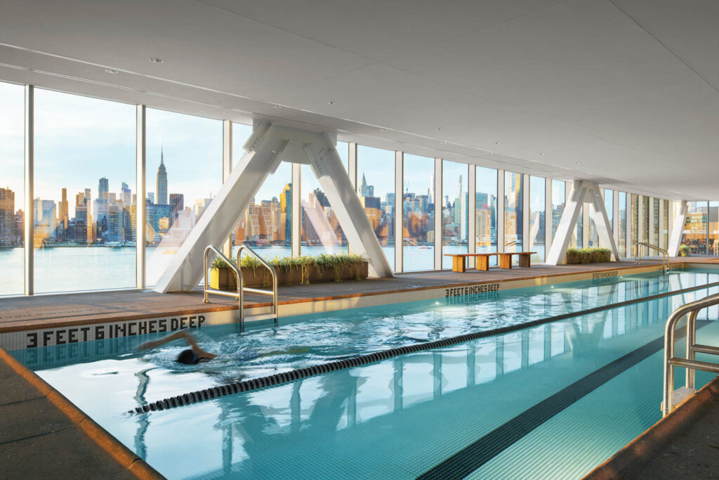 an amenity bridge that houses a 75-foot indoor lap pool links two residential towers