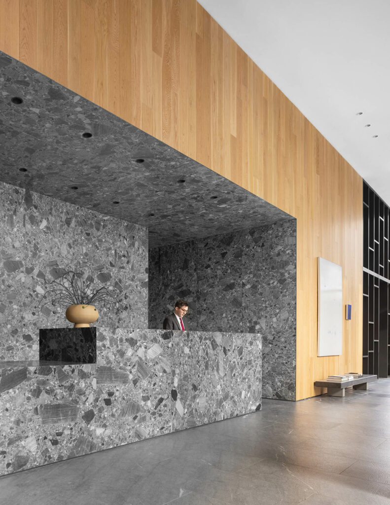 a lobby with a breccia stone reception area 