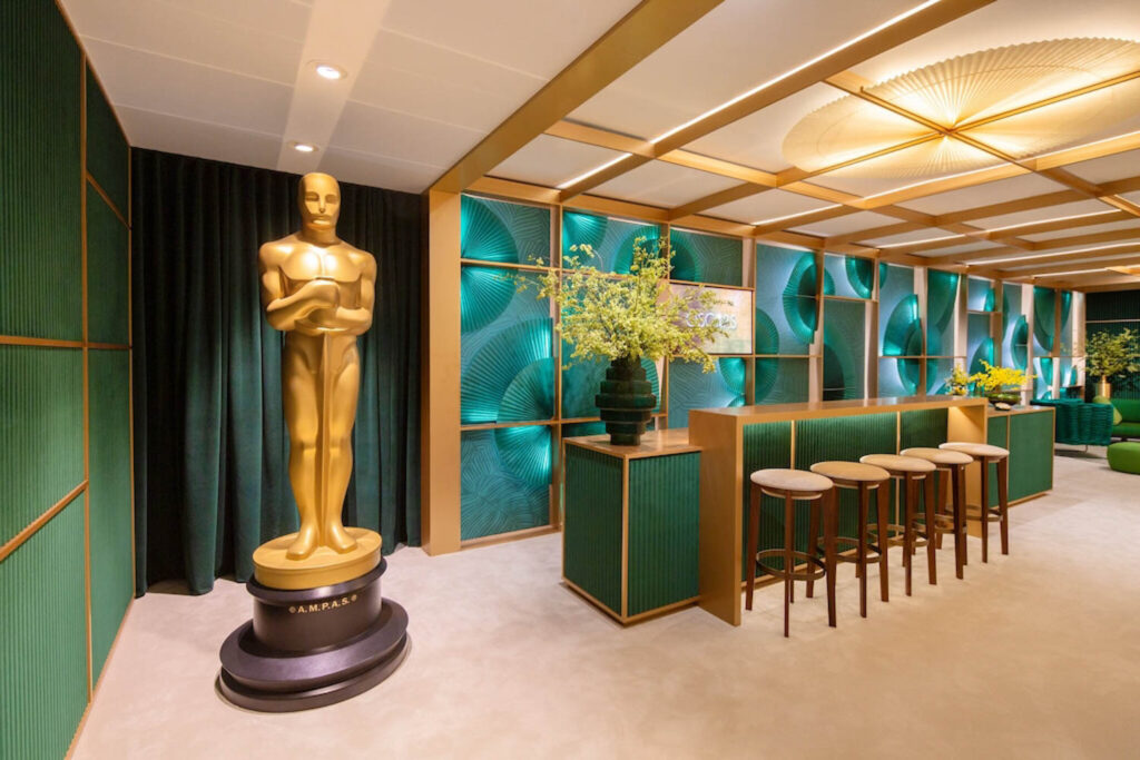a gold oscar statue stands inside the greenroom