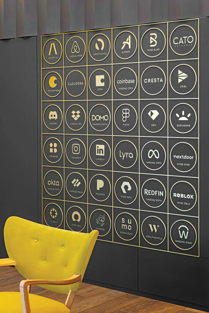 poster with buttons hanging above yellow chair