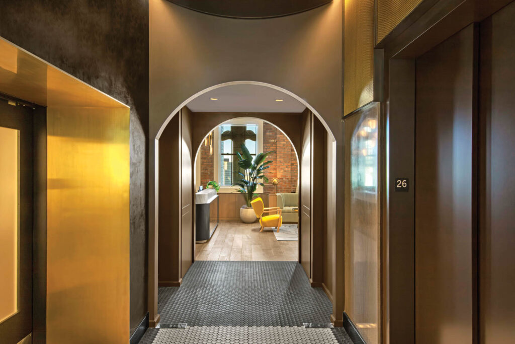 hallway with wooden paneled walls and carpeted floors