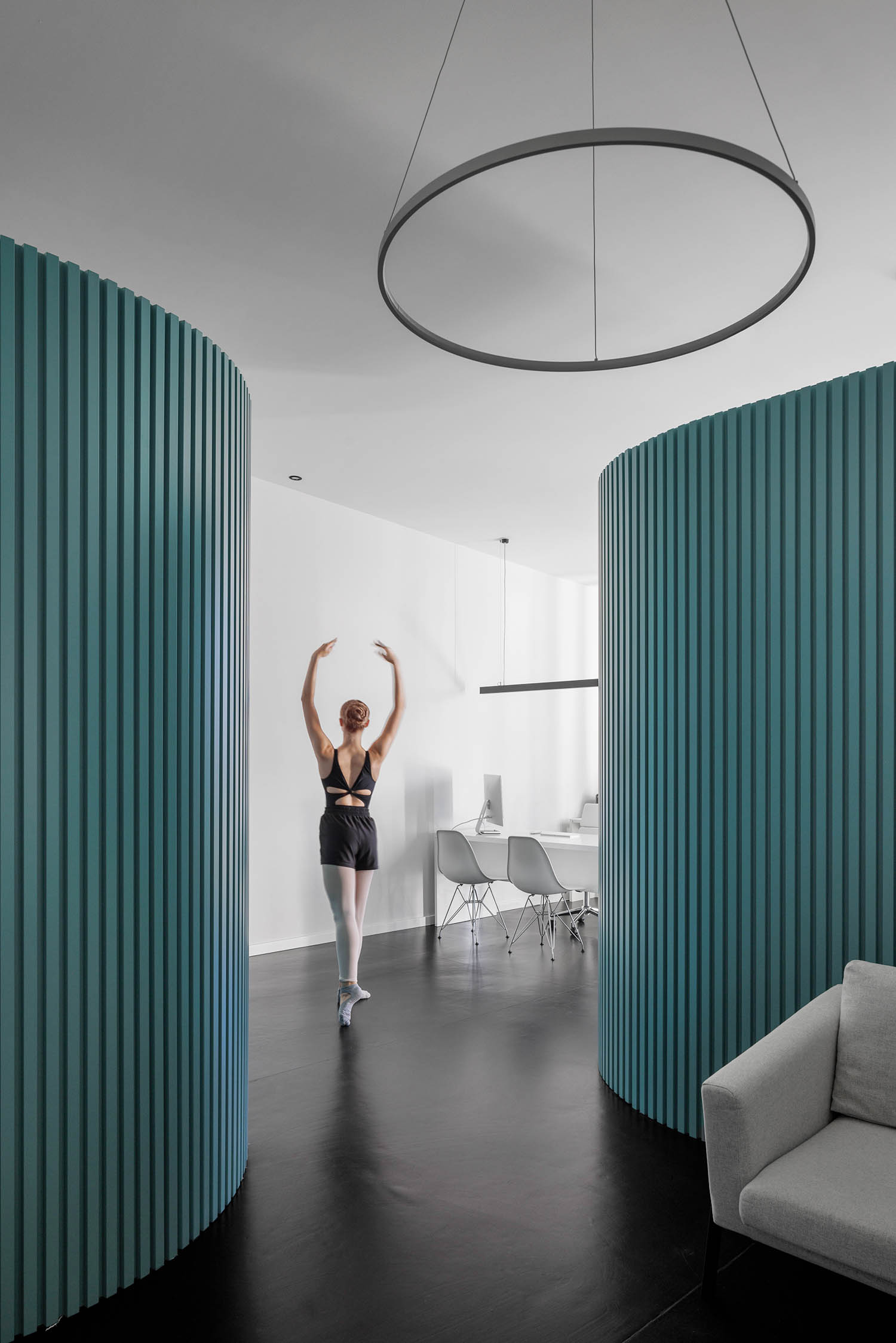 ballerina in room with green dividers