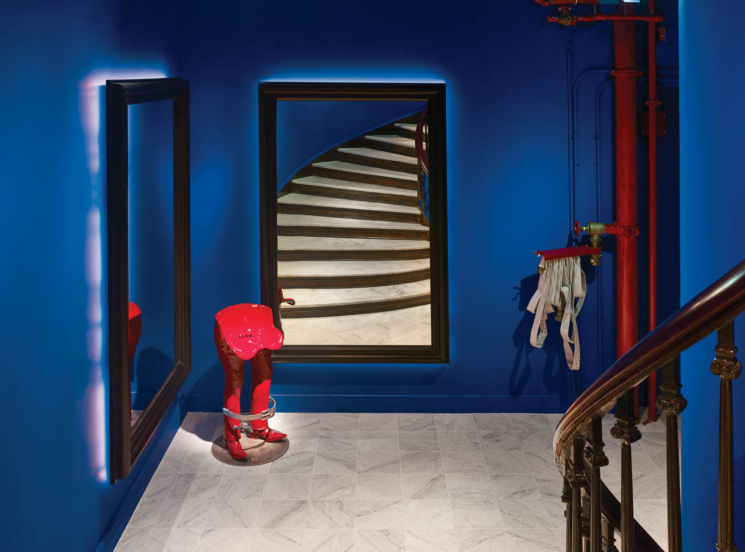 blue room with mirrors, red sculpture and stairs