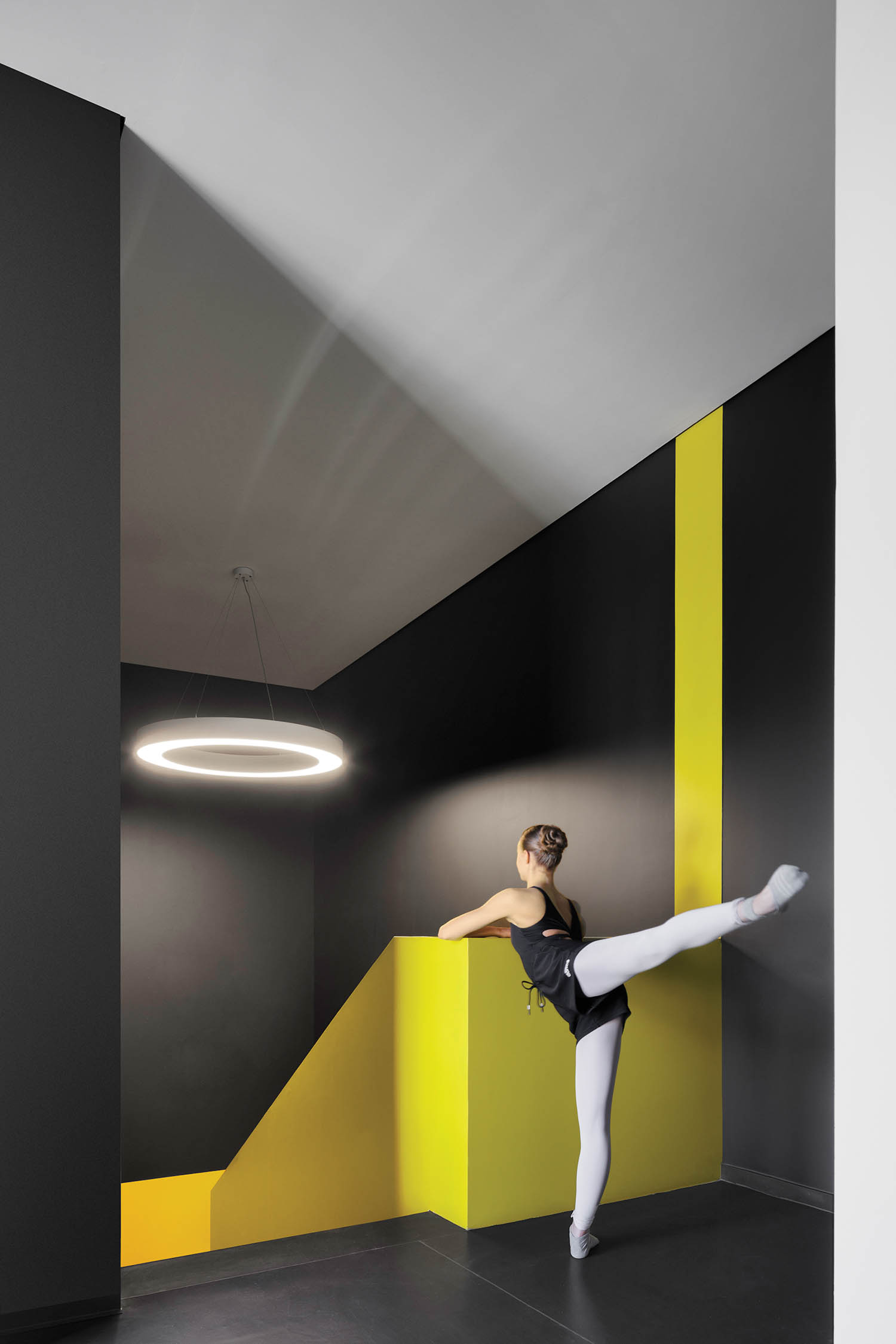 black dance room with yellow bar and structures