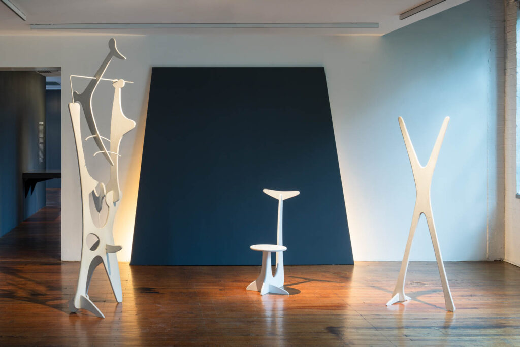 showroom with white sculptures and blue focus wall