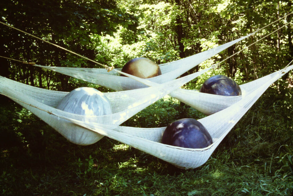 different colored balls in hammocks in the garden