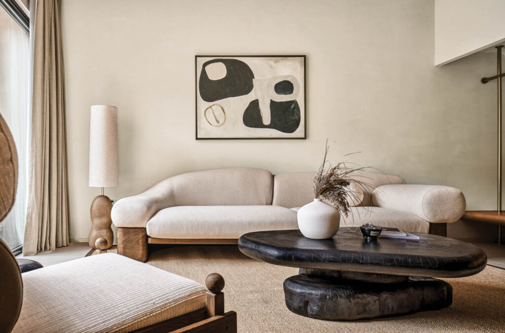 sitting room with white couch, black and white art